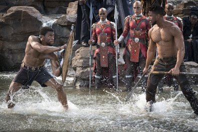 T'Challa (Chadwick Boseman) and Killmonger (Michael B. Jordan), with Janeshia Adams-Ginyard in the background. (c) Marvel Studios