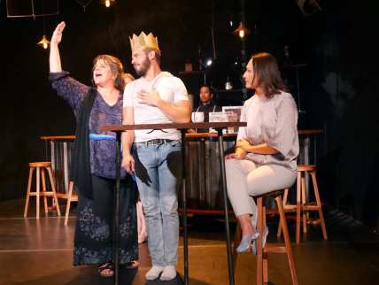 Aunt Helen (J.J. Van Name), John (Paul Rodrigues), and Roxy's (Stephanie Whigham) lives go on under the watchful eye of the mysterious bartender (Enormvs Muñoz). Photo courtesy of Theatre of Yugen.